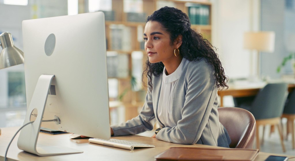 Procurement professional using AI-assisted purchasing tools at a modern workstation